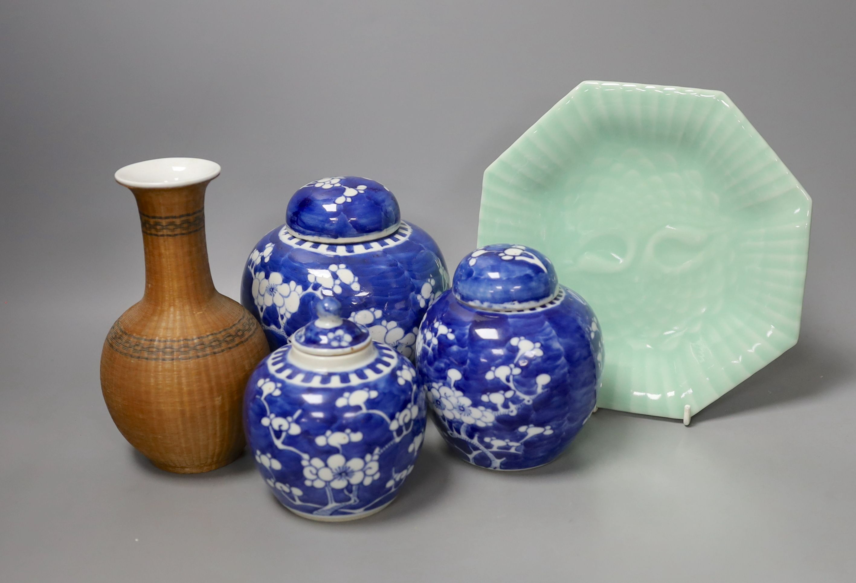 Three Chinese blue and white ginger jars and covers, a celadon plate and bamboo covered vase (5)